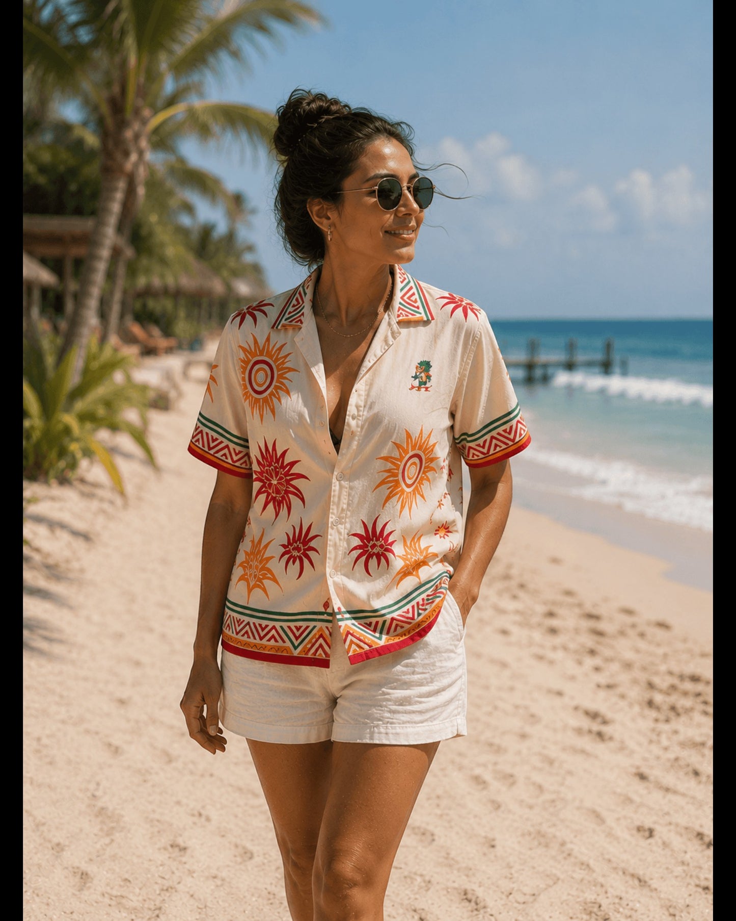 Woman wearing a Retrooo.com cream Hawaiian shirt with sun patterns and a small embroidered Quetzalcóatl on the chest.